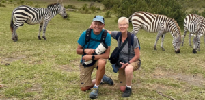 a couple interacts with zebras on their romantic holiday safari at lake naivasha,kenya