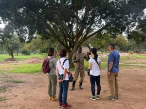 Our clients with their park ranger - listening to the dos and don'ts when tracking for the ziwa rhinos in Uganda